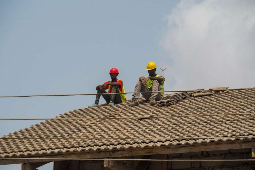 Two construction workers are taking a break.