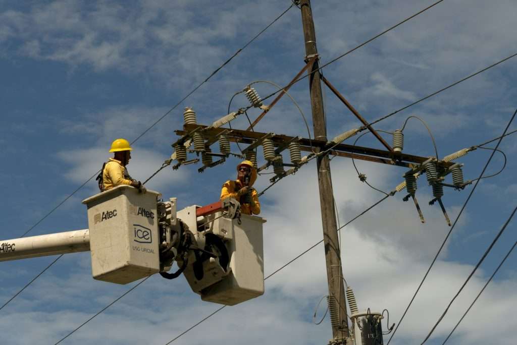 A couple of men working on a power line